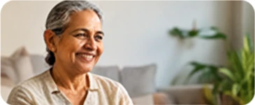 Smiling patient reading an appointment reminder on a tablet at home